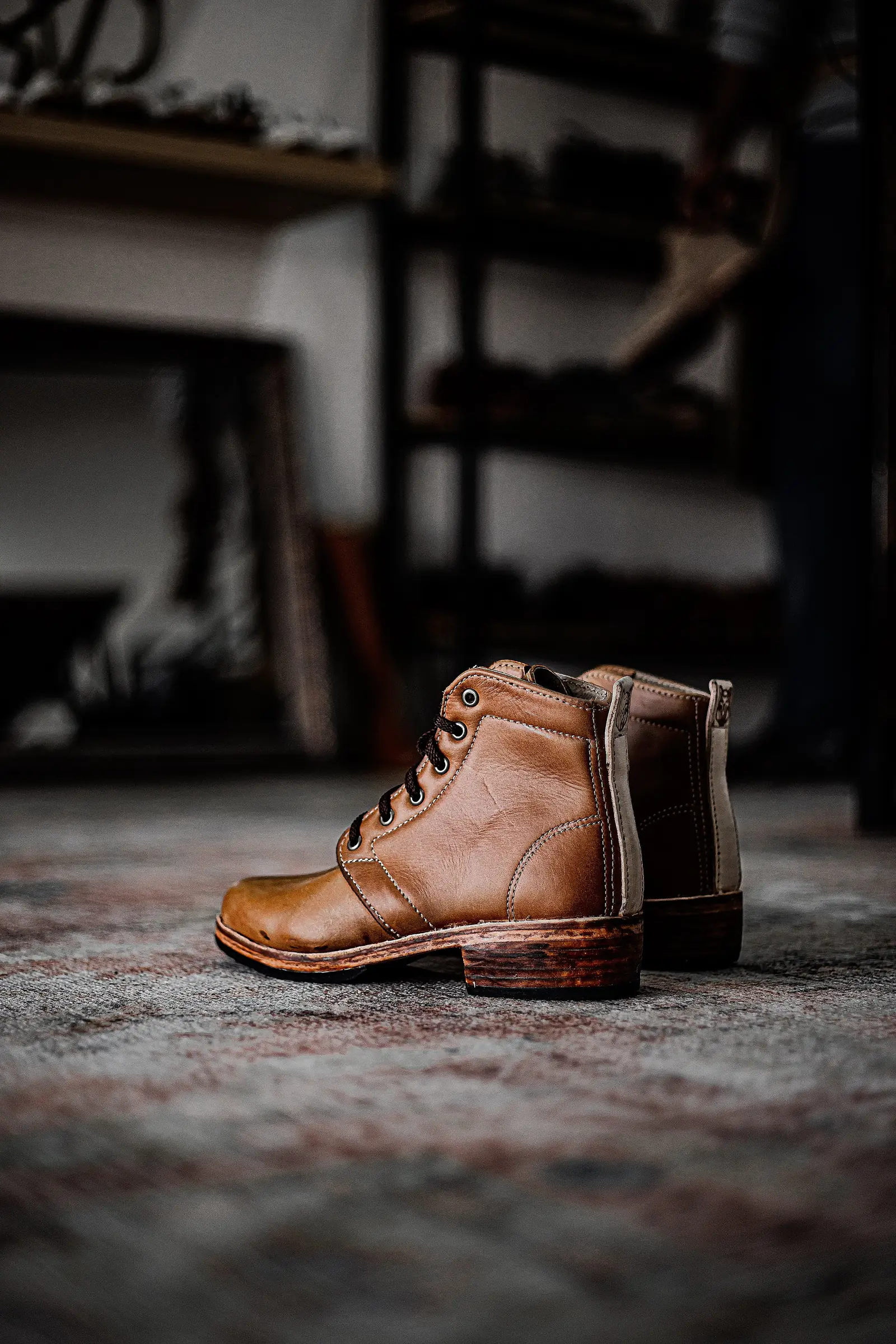 A tan boot standing on the rug in the Room