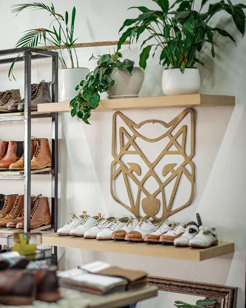 The wolf on the wall of the Room, above a shelf of finished pairs